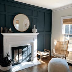 a living room filled with furniture and a fire place in front of a mirror on the wall