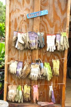 several pairs of gloves hanging on a clothes line