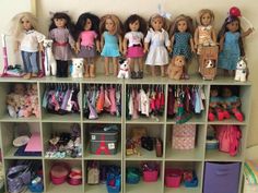 a bunch of dolls that are on some shelves