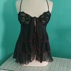 Black And Red Chemise. Ties At Top And Opens. Elastic In The Back Lace Detailing And Adjustable Straps. Never Worn And In Excellent Condition. Size Large. Black Flirty Camisole Top, Flirty Black Camisole Top, Black Coquette Tops For Party, Black Coquette Party Tops, Black Sheer Tops For Night, Black Coquette Camisole Top, Black Coquette Top For Night Out, Black Coquette Summer Tops, Summer Black Coquette Tops