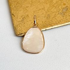 Estate 14KT yellow gold iridescent mother of pearl oblong/ abstract shaped pendant charm. Bail opening: 3mm No chain included Both sides are mother of pearl Measures: 25 x 14mm Not stamped, but guaranteed Polished Mother Of Pearl Necklace For Gift, Polished Mother Of Pearl Pendant Jewelry, Polished Mother Of Pearl Pendant Necklace, Mother Of Pearl Jewelry With Large Pendant As Gift, Mother Of Pearl Large Pendant Jewelry Gift, Mother Of Pearl Pendant Jewelry As Gift, Gold Teardrop Pendant Jewelry With High Luster, Teardrop Pendant Jewelry With High Luster For Gifts, Modern High Luster Jewelry As Gift