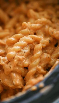 macaroni and cheese is being stirred in a bowl