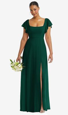 a woman in a green dress holding a bouquet