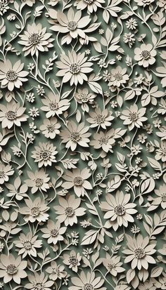 an intricately designed wall with white flowers on green and gray background, closeup