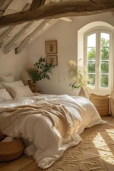 a bed sitting under a window in a bedroom next to a basket filled with flowers