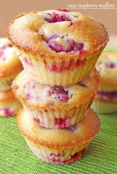 three strawberry muffins stacked on top of each other with text overlay that reads easy raspberry muffins