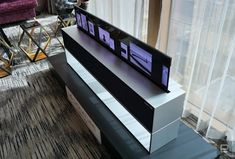 a large flat screen tv sitting on top of a stand