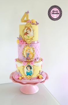 a three tiered cake decorated with princesses and the number four on it's side