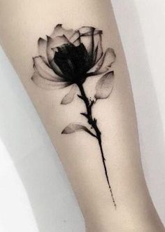 a black and white photo of a flower on the left arm, with watermarked petals