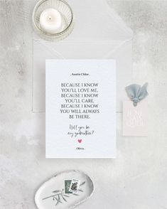 a white card with a quote on it next to a candle and some other items