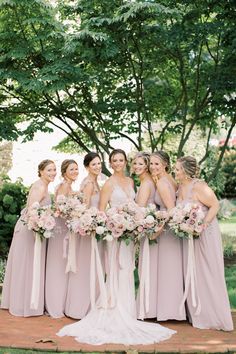 a bride and her bridal party in pink dresses