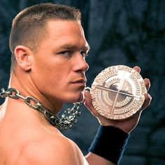 a man in chains holding up a medal