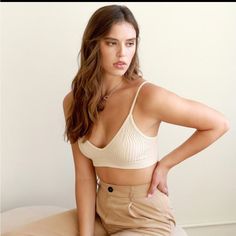 Ribbed V-Neck Seamless Bralette (Pearled Ivory) Perfect Add On To Your Closet To Wear Under A Staple Blazer! Materials: 92% Nylon/8% Spandex Model Is 5'4 And Wearing A Size O/S Elegant V-neck Bra For Spring, Beige Seamless V-neck Crop Top, Chic Seamless Bra For Spring, Elegant V-neck Summer Bra, Beige Triangle Top Crop Top, Chic Seamless Low-cut Bra, Beige Triangle Crop Top, Elegant V-neck Bra, Spring Cream Bra