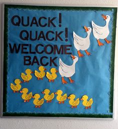 there is a sign that says quack welcome back with ducks in the water and on the wall