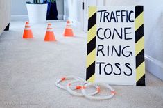 a traffic cone ring toss sign sitting on the floor