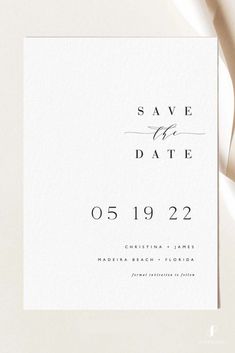 an elegant save the date card is displayed on top of a white paper with black ink