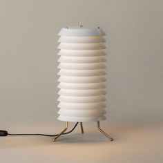 a lamp that has been turned on and is sitting on a stand with a cord attached to it