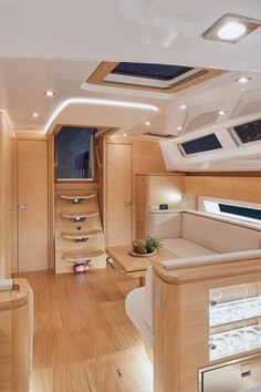 the interior of a boat with wood floors and white walls, including an open area for seating