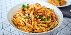 a white bowl filled with pasta and sauce