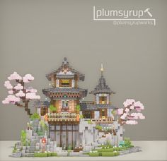 an image of a building made out of legos with cherry blossoms on the trees