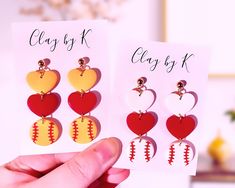 two pairs of heart shaped earrings are shown in front of a card with the words classy k on it