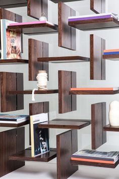 shelves with books and magazines on them in a room that looks like it is made out of wood