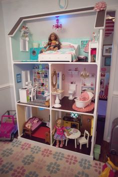 a doll house with dolls and furniture inside