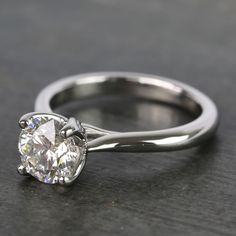 a diamond ring sitting on top of a table