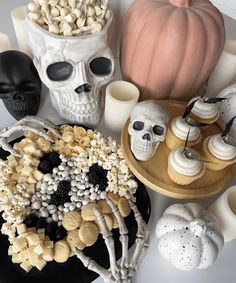 a table topped with halloween decorations and skulls