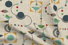 the fabric is very colorful and has circles, dots, and leaves on it's white background