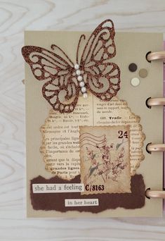 an altered book with a butterfly on it