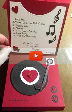 someone is making a record player card out of an old cd and some music notes