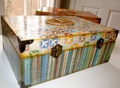 a multicolored wooden box sitting on top of a table next to a window