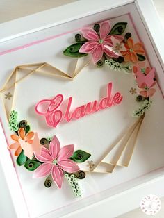 a handmade card with flowers and the word glaude written in pink on it