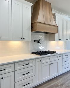 a kitchen with white cabinets and an oven