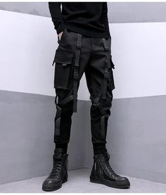 Dominate the urban battlefield in our darkwear cargo pants. Experience the Darkwear Pants, the epitome of tactical streetwear that transforms the courageous urban dweller into a figure of intrigue and allure. Imagine yourself striding confidently down the concrete jungle, your stride unhindered and your style unmatched, a living, breathing testament to the elegant power of future streetwear. Every feature of these unique pants serves to enhance your commanding presence. The darkwear cargo pants, Hip Hop Cargo Pants, Mode Harajuku, Techwear Pants, Estilo Harajuku, Cargo Pants For Men, Streetwear Hip Hop, Black Cargo Pants, Style Japonais, Safari Style