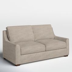 a beige couch sitting on top of a white floor