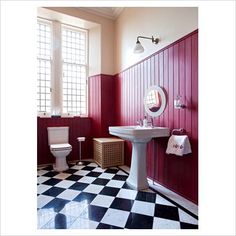 a bathroom with a checkered floor and red walls