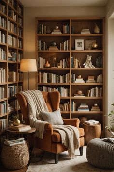 a living room filled with lots of bookshelves next to a chair and ottoman