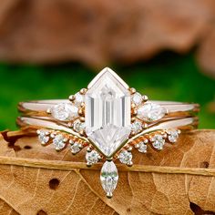 a close up of a ring on top of a leaf