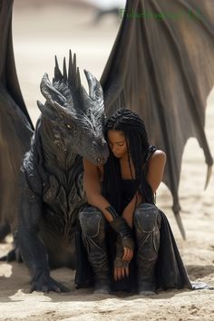 a woman sitting next to a statue of a dragon