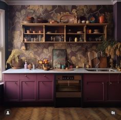 a kitchen with wooden floors and purple walls, decorated with floral wallpaper in the corner