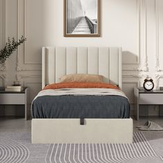 a bed with a white headboard and foot board in a room next to two nightstands