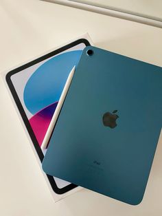 two different colored ipads sitting next to each other