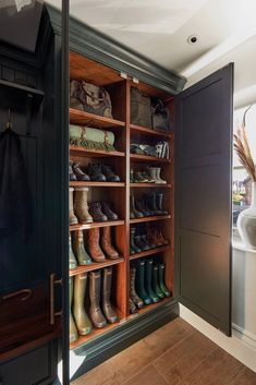 a closet with wooden shelves filled with shoes