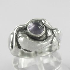 Demeter-Mistress of Land and Sea depicting serpent and dolphins. Sterling Silver with 5 mm gemstone choice. Shown with Amethyst. Measures 18 mm at widest point. Comes with meaning card and gift box. SKU R68 Mystical Round Amethyst Ring For Gifting, Mystical Round Amethyst Ring Gift, Mystical Amethyst Ring As A Gift, Mystical Amethyst Ring In Sterling Silver, Amethyst Mermaid Ring, Rings With Gemstones, Spiritual Amethyst Cabochon Ring For Gift, Silver Amethyst Ring, Spiritual Birthstone, Black Ring Box