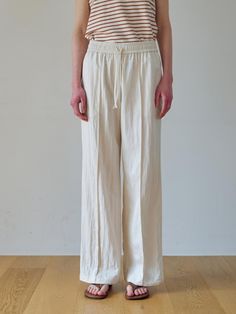 These wide-leg pants offer a versatile and modern style suitable for various occasions. It features the relaxed fit for comfortable wear experience.- Subtle pin tucks at the front for added flair- Drawstring detail on the inside of the hem for a jogger-style look- Elasticated waistband for comfort* The color may vary according to the monitor resolution. Beige Wide Leg Pants With Relaxed Fit, White Linen Wide Leg Pants With Straight Hem, Cream Wide Leg Relaxed Fit Pants, Beige Wide Leg Pants With Straight Hem, Relaxed Fit Wide-leg Rayon Pants, Cream Wide-leg Sweatpants With Elastic Waistband, White Wide-leg Pants With Elastic Waistband, Fashion Joggers, Wide Pants