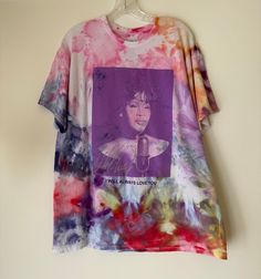 Super fun hand dyed Whitney Houston tie-dye t-shirt. This unique tee is a fun addition to your closet or to give us a gift. Artistic Tie Dye Cotton Tops, Funky Short Sleeve Cotton T-shirt, Bleached Multicolor Graphic Tee, Pre-washed Tie Dye T-shirt For Summer, Hand Dyed Tie Dye Graphic Tee, Hand Dyed Tie-dye Graphic Tee, Hippie Hand Dyed Tie Dye T-shirt, Batik Shirt, Whitney Houston