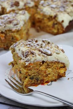 a piece of carrot cake on a plate with a fork