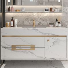 a bathroom vanity with white marble and gold accents